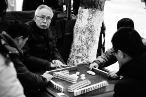 Men playing Mahjong at the roadside in Nanjing Men playing Mahjong at the roadside in Nanjing